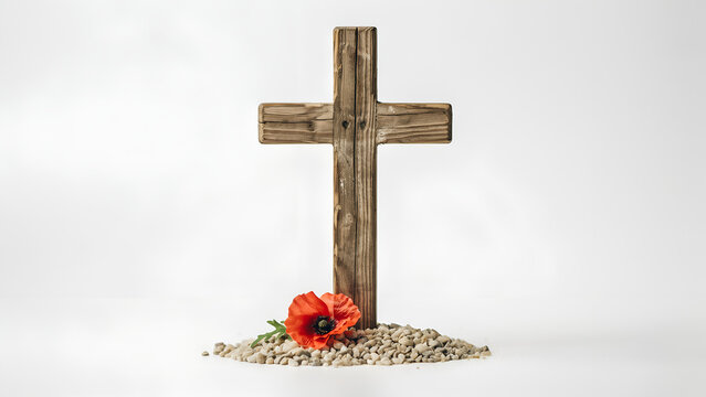 Rustic wooden cross with a single poppy flower on gravel during remembrance day concept