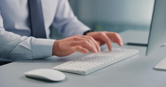 Man in shirt and tie typing on keyboard, professional, office