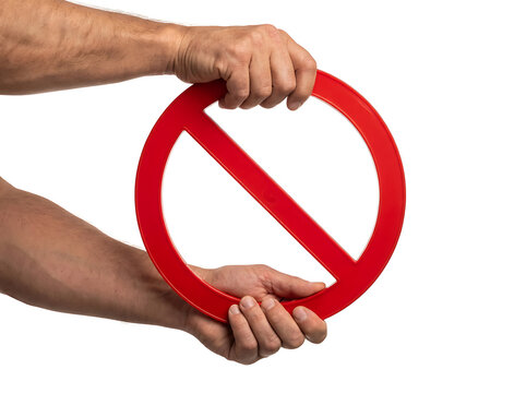 Hands holding red prohibition sign against white background for regulatory compliance and safety communication templates with prohibition restriction compliance regulation security
