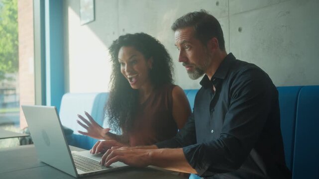 Excited entrepreneur couple cheering successful AI startup project on laptop outdoors (84)