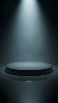 Dark circular podium under a spotlight