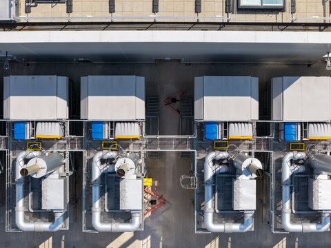 Aerial view of Data Center cooling units and industrial infrastructure with metallic pipes and ventilation systems in the United Kingdom.