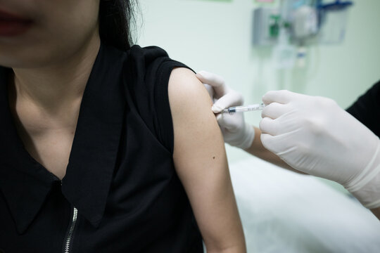 Close up doctor hand making vaccination in the shoulder of patient.Flu vaccination injection on arm.Vaccine disease preparing for human papilloma virus.