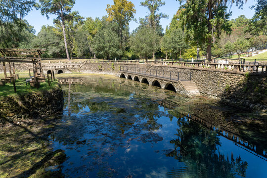 Radium Springs Gardens in Albany, Georgia. Courtyard of former Radium Springs Casino, foliage-draped hillocks, crystal clear waters, radium springs from underground cave.