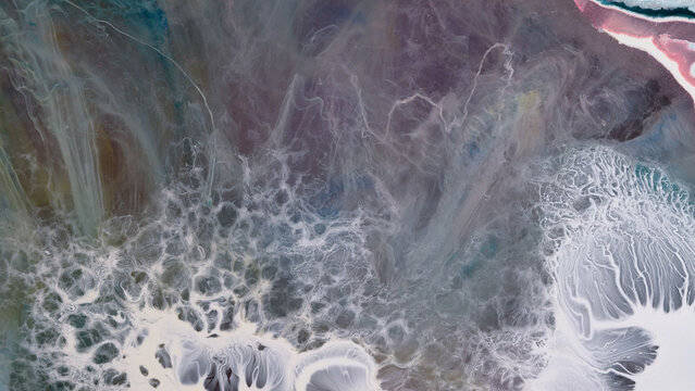 Creating art with alcohol ink and epoxy resin in a studio