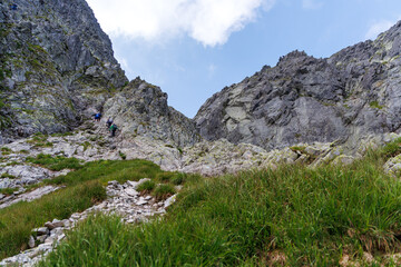 Hikers Ascending Steep Rocky Pass in High Tatra Mountains © Jorens