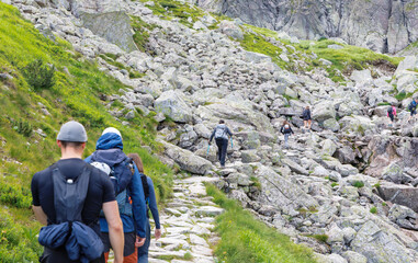 Hikers Ascending Rocky Tatra Path © Jorens