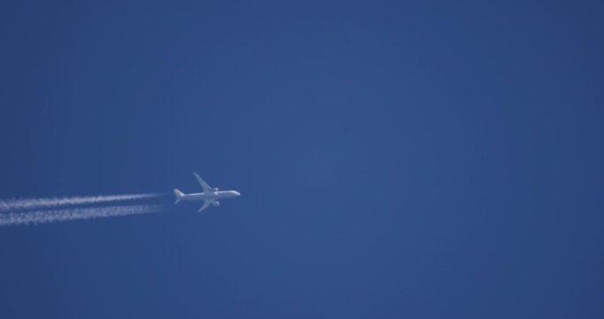 Real Passenger Jet with Contrail in Clear Blue Sky, Slow Motion Telephoto Static Shot, No People