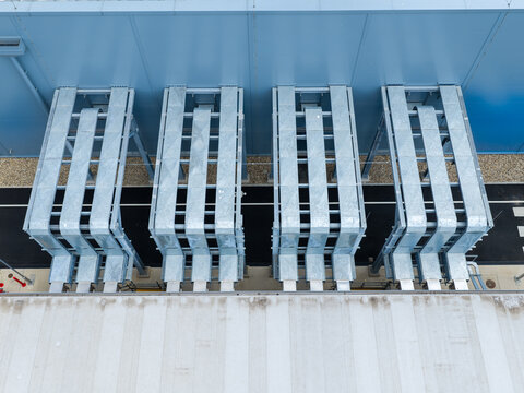Aerial view of the external ventilation infrastructure of a data center with metallic ducts and blue walls in United Kingdom.