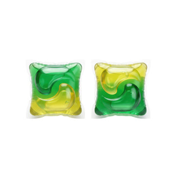 Two translucent laundry detergent pods with swirling green and yellow liquid on a transparent surface representing a modern household cleaning product concept
