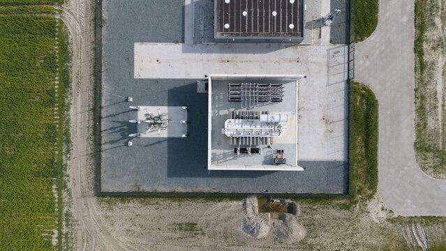 Aerial view of High Voltage Electrical Substation Surrounded by Farmland