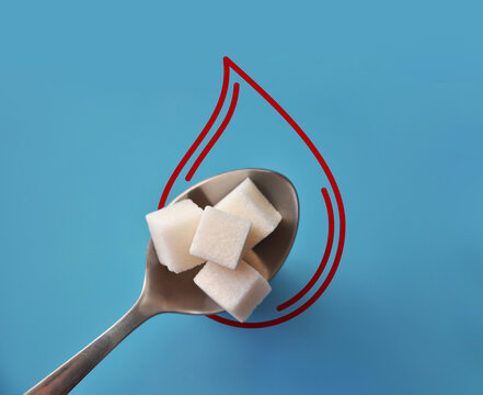 Sugar Cubes in Spoon Inside Blood Drop Symbol Representing Blood Sugar Level