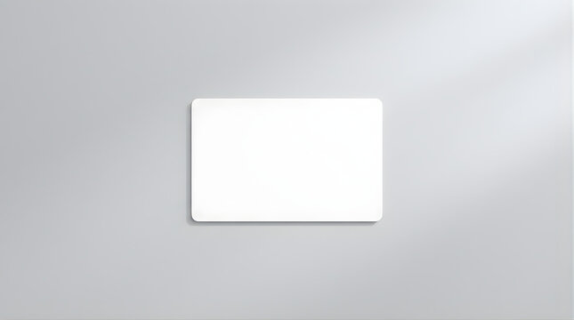 Blank White Rectangular Card with Rounded Corners Casting a Subtle Shadow on a Smooth Light Gray Background Representing an Abstract Concept or Template