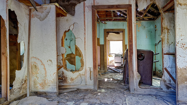 Panorama of the broken drywall and an old furnace in the interior rooms of an abandoned house