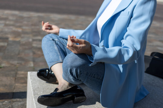 Businesswoman meditating outdoors finding zen and balance
