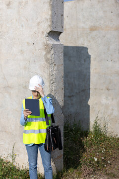 Female engineer working with digital tablet at construction site
