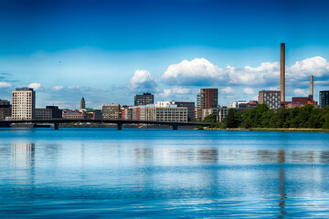 Obraz premium Modern residential buildings in the Sompasaari district viewed across the water from Mustikkamaa island in Helsinki, Finland, on a sunny, cloudless summer day. HDR.