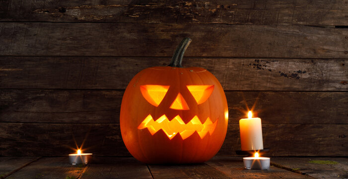 Halloween pumpkin lantern with burning candle inside