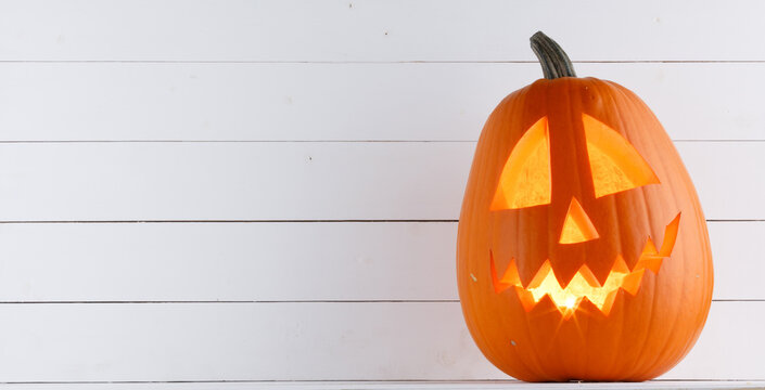 Halloween pumpkin lantern with burning candle inside