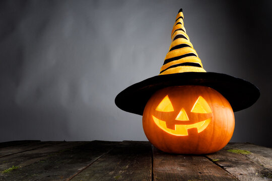 Halloween pumpkin lantern with burning candle inside