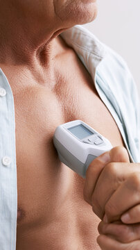 Lung function test patient chest profile holding digital spirometer closeup medical examination
