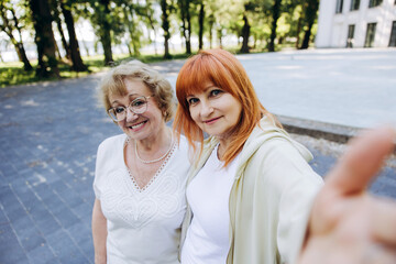 Fototapeta premium Senior women enjoying friendship and taking selfie outdoors