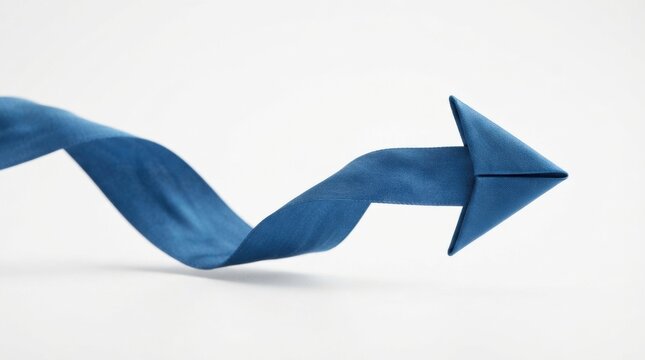 Twisting blue silk ribbon arrow on white background for directional banner design and minimalist abstract concept composition