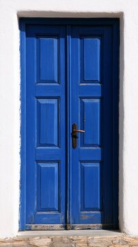 Blue wooden door in traditional greek island architecture