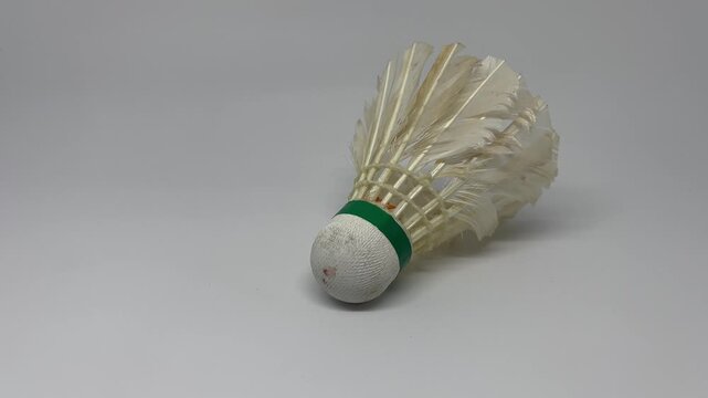 Single badminton shuttlecock on clean neutral background for active lifestyle
