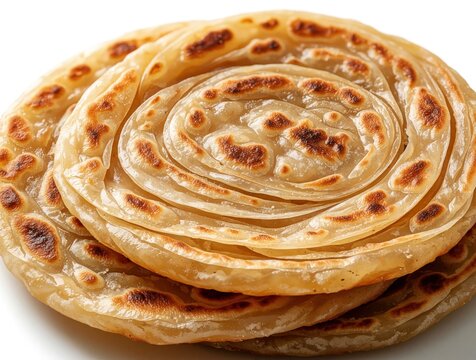 Stack of flaky Kerala parotta flatbreads. Golden brown baked wheat dough with layered texture. Delicious Indian cuisine served on white background.