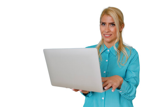 Blonde business woman standing, smiling while typing on a laptop. She is connecting, innovating, and engaging with digital work