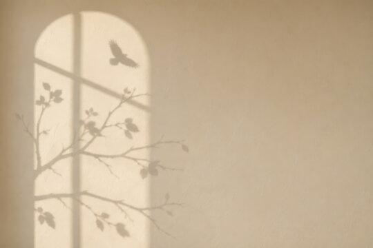 Arched window silhouette shadow casting tree branches and flying bird on beige wall for halloween greeting card with halloween silhouette branches greeting background minimalist atmospheric