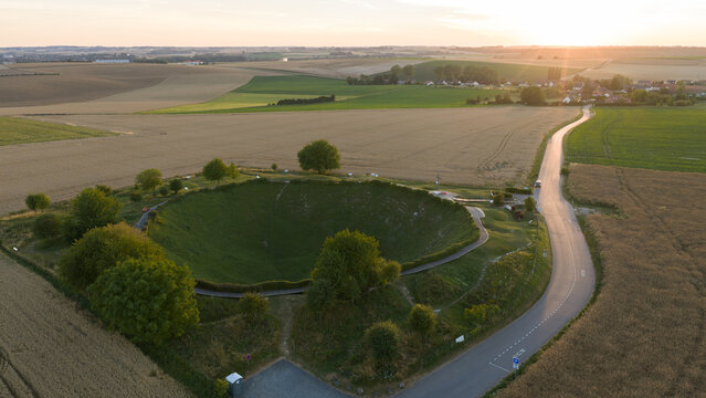 Aerial view of Lochnagar Crater WW1, a massive historic explosion site surrounded by agricultural fields and rural roads in Ovillers-la-Boisselle, Hauts-de-France, France.