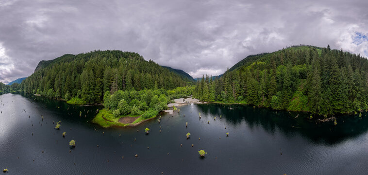 Aerial Panoramic of Forested Lake and River Valley Near Chilliwack, British Columbia, Canada Under Moody Clouds
