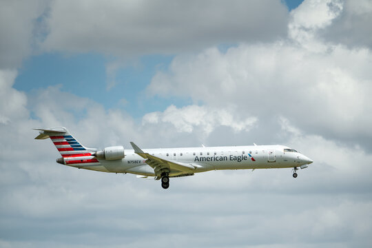 American Eagle aircraft Bombardier CRJ-700 approaching Dallas Fort Worth International Airport (DFW). Storm clouds.