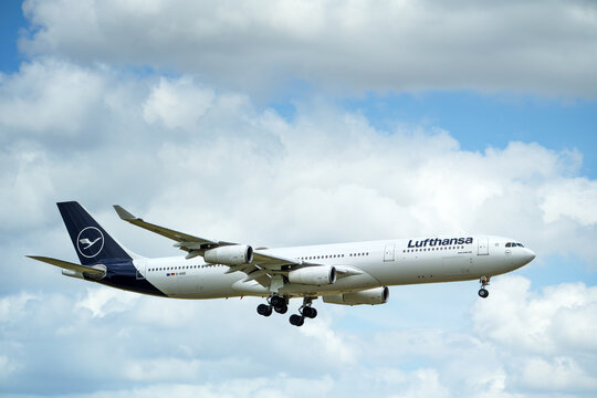 Lufthansa aircraft Airbus A340-313 approaching Dallas Fort Worth International Airport (DFW). Storm clouds.