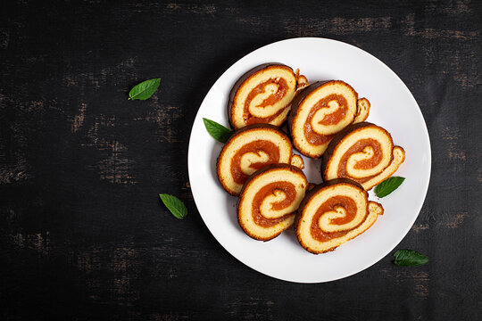 Traditional Swiss Roll with Apricot Filling and Fresh Apricots. Top view