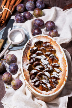 German plum cake with cinnamon, served with ice cream and coffee.