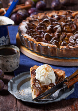 German plum cake with cinnamon, served with ice cream and coffee.