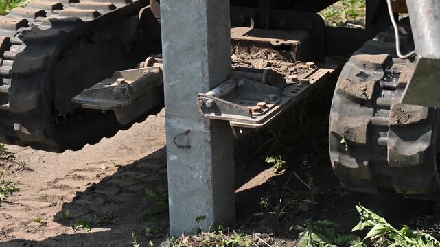 Diesel hammer drives concrete piles for a country house.