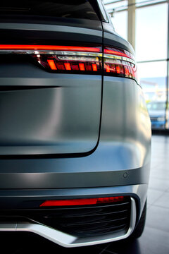 illuminated car tail lights at night close-up in modern automotive setting with glass and plastic materials and dynamic modern mood for in automotive and transportation.