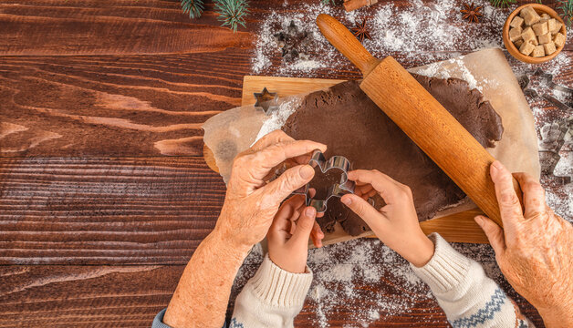 Grandmother Teaching Child to Make Christmas Gingerbread