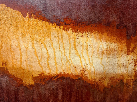 The close-up of a rusted metal surface showcases a blend of orange and brown hues, creating an abstract and organic texture