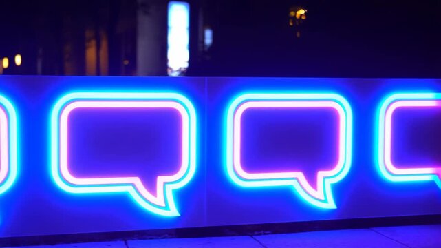 Neon speech bubble signage row glowing cyan and magenta on nighttime street, rounded panels with layered tube outlines, urban bokeh, reflective pavement, retro commercial display