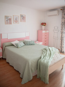 Pretty boho styled bedroom with fresh cut flowers and pink sheepskin