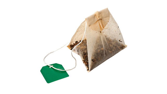 Single unused tea bag with green tag herbal organic drink isolated on transparent background cut out