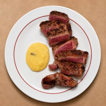 Grilled Medium Rare Beef Steak with Creamy Polenta on White Plate Fine Dining