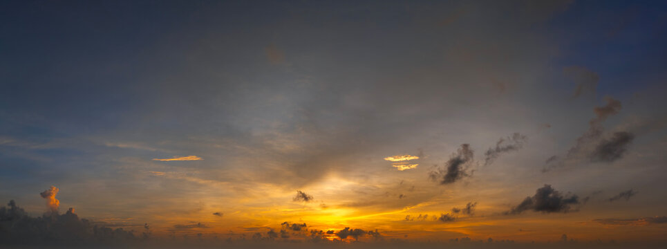 Amazing sunset skyscape. Evening sky with bright colorful orange and yellow clouds