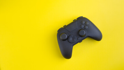 Flat Lay Blank Black Gamepad Mockup on Yellow Background with Copy Space  © wibiwisnu