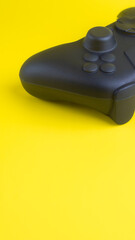 Vertical Close Up of Blank Black Gamepad Mockup on Yellow Background  © wibiwisnu